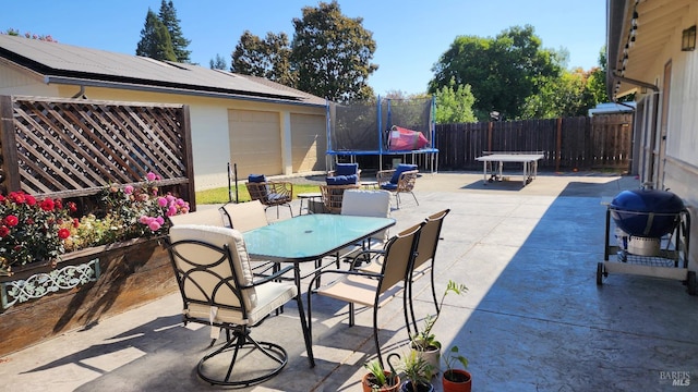 view of patio featuring a trampoline and area for grilling