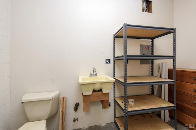 bathroom with concrete floors and toilet