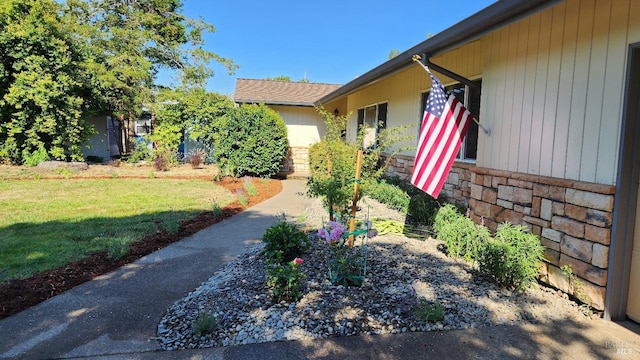 doorway to property featuring a yard