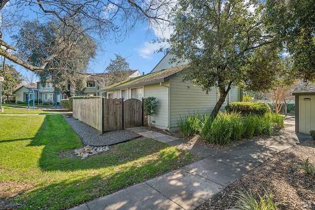 view of side of home with a lawn