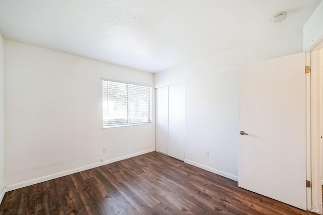 empty room featuring dark wood-type flooring