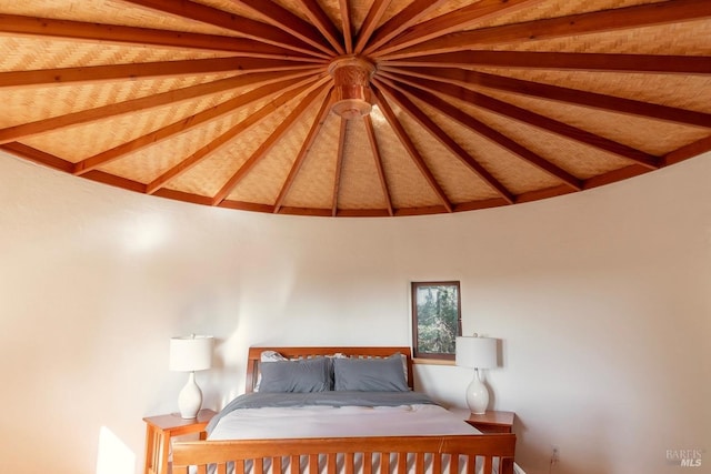 unfurnished bedroom with wooden ceiling and lofted ceiling with beams