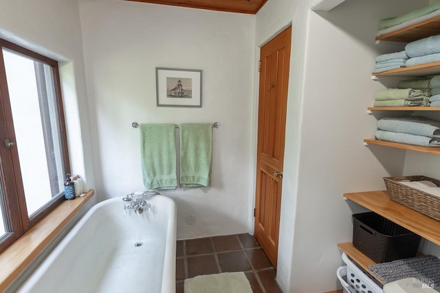 bathroom featuring tile patterned flooring and a tub