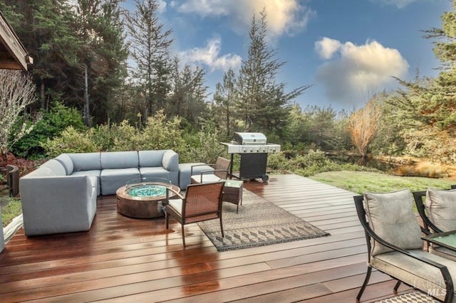 wooden deck with an outdoor living space with a fire pit and a grill