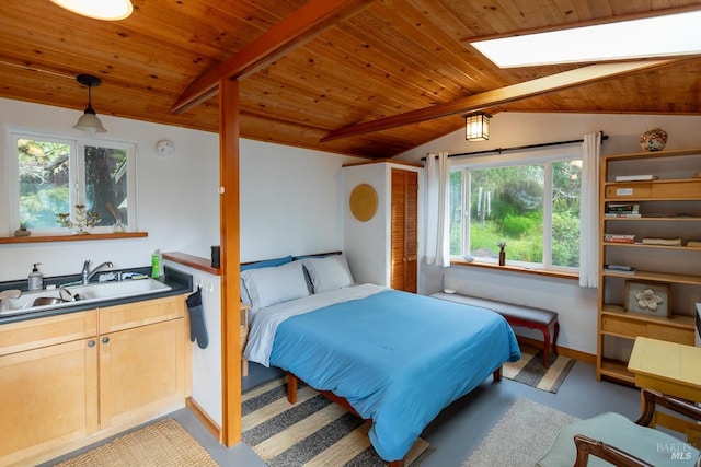 bedroom with wooden ceiling, vaulted ceiling with skylight, multiple windows, and sink