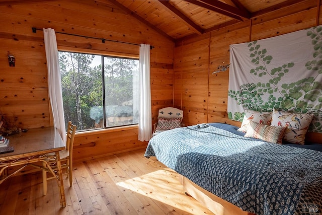 bedroom featuring wooden ceiling, hardwood / wood-style floors, wood walls, and lofted ceiling with beams