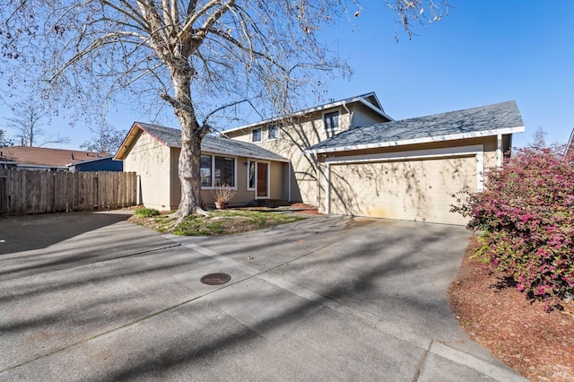 view of front of house with a garage, driveway, crawl space, and fence