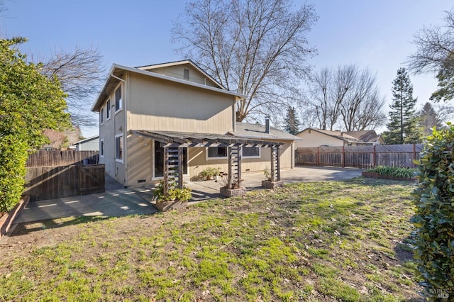 back of property featuring a fenced backyard, a lawn, and a patio