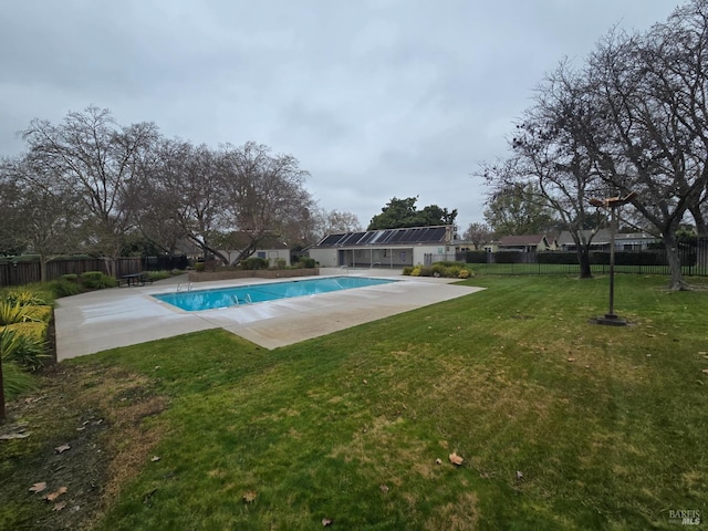 view of swimming pool featuring a patio area, a fenced backyard, and a lawn