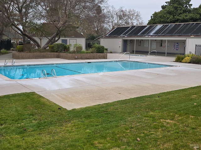 pool featuring a lawn and a patio