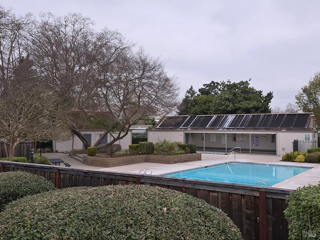 pool featuring a patio and fence