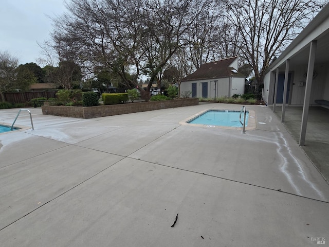 view of pool with a patio area, fence, and a fenced in pool