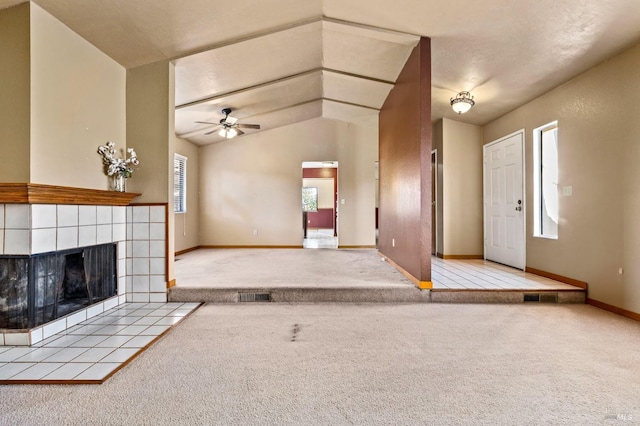 unfurnished living room featuring a fireplace, light colored carpet, visible vents, ceiling fan, and baseboards