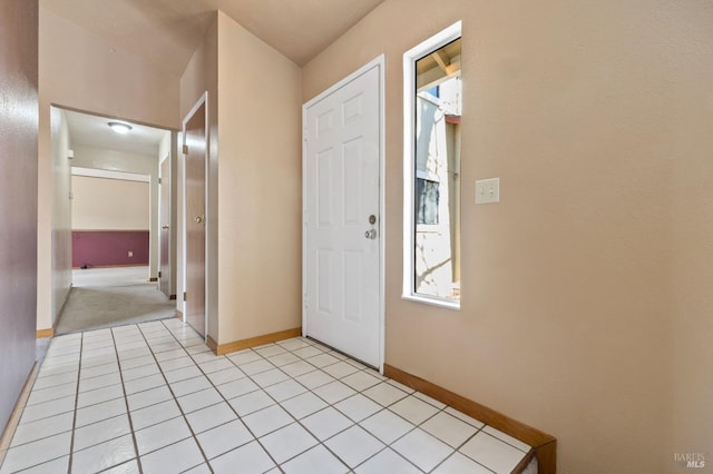 entryway featuring light tile patterned flooring and baseboards