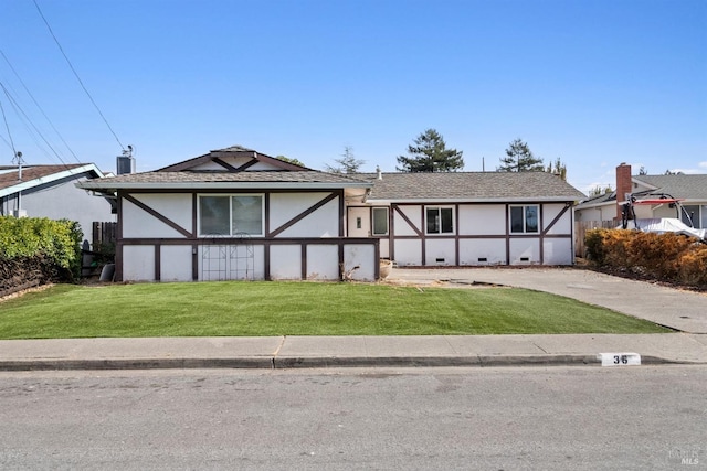 tudor-style house featuring a front lawn