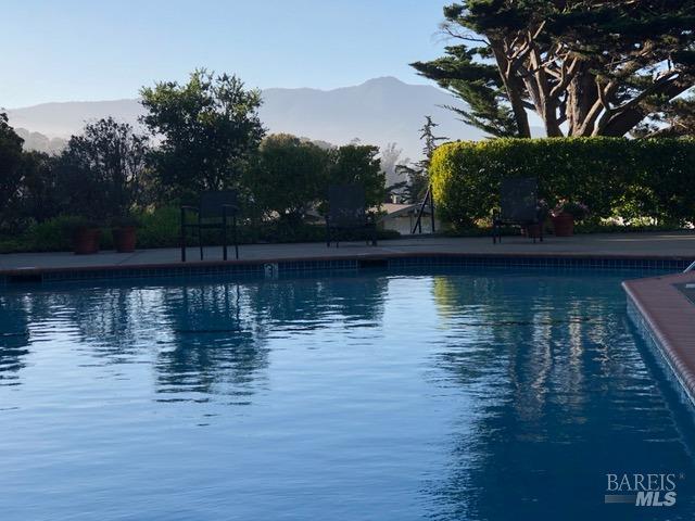 view of swimming pool with a mountain view