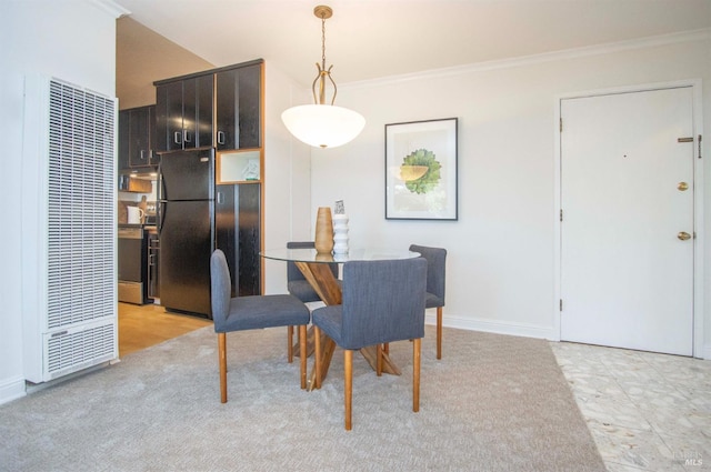 dining space with crown molding