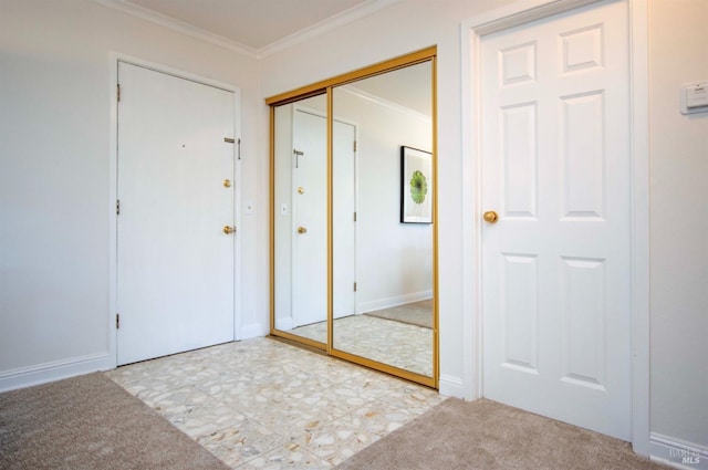 interior space with light colored carpet, ornamental molding, and a closet