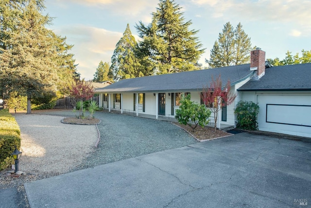 view of front of property featuring a porch and a garage