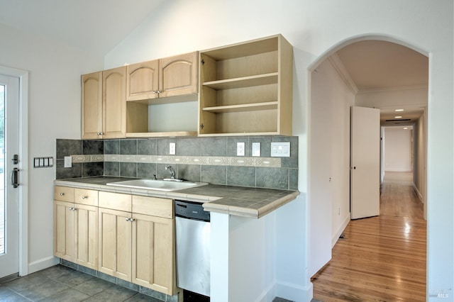 kitchen with tile counters, decorative backsplash, sink, light brown cabinetry, and stainless steel dishwasher