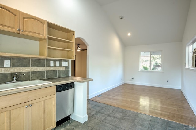 kitchen with ceiling fan, dishwasher, decorative backsplash, sink, and tile counters