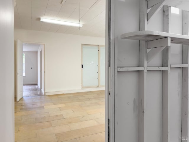 corridor with light hardwood / wood-style flooring