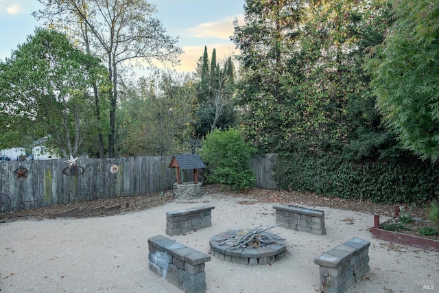 patio terrace at dusk featuring an outdoor fire pit