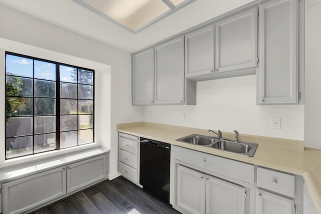 kitchen with dark hardwood / wood-style flooring, dishwasher, and sink