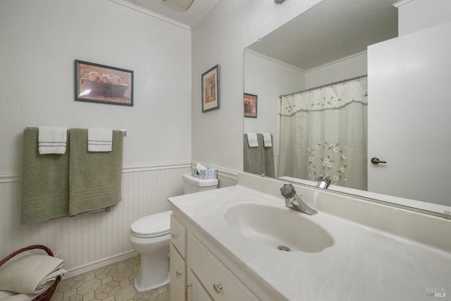 bathroom featuring toilet, ornamental molding, tile patterned floors, and vanity