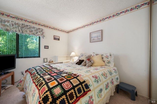 carpeted bedroom featuring a textured ceiling