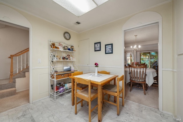 carpeted dining area with a notable chandelier