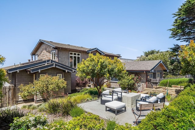 back of property with outdoor lounge area and a patio