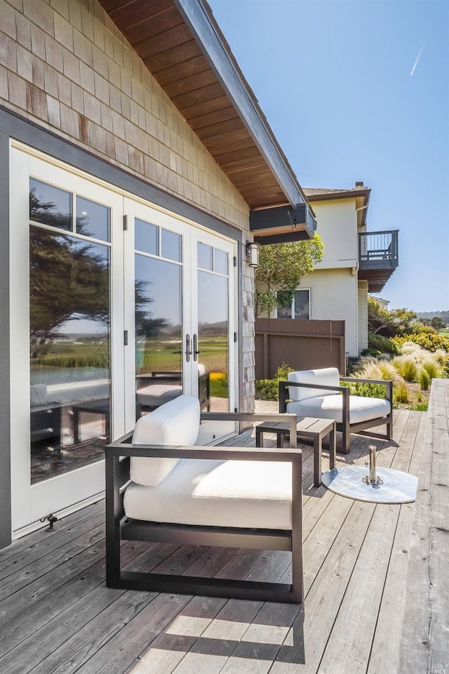 wooden terrace featuring outdoor lounge area and french doors