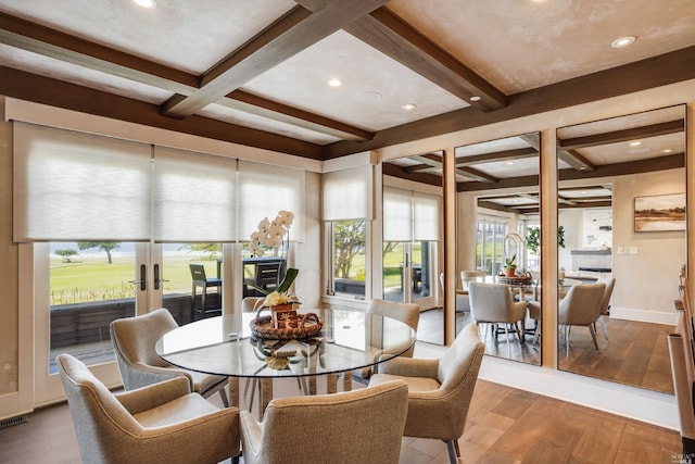 dining space featuring hardwood / wood-style floors, beam ceiling, and coffered ceiling