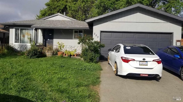 ranch-style home with a front lawn and a garage