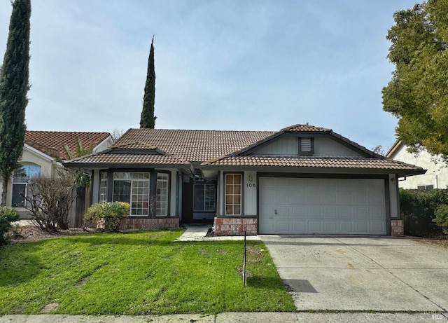 view of front of property with a front lawn and a garage