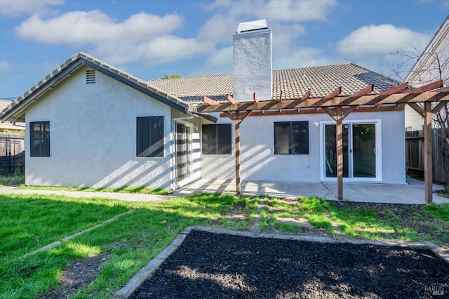 back of property featuring a patio, stucco siding, a chimney, a pergola, and fence