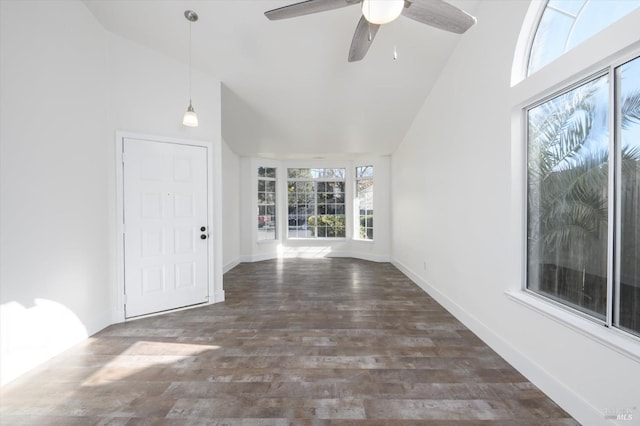 interior space featuring wood finished floors, high vaulted ceiling, baseboards, and a ceiling fan