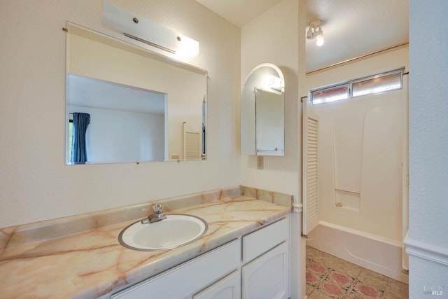 bathroom with tile patterned floors, vanity, and shower / washtub combination