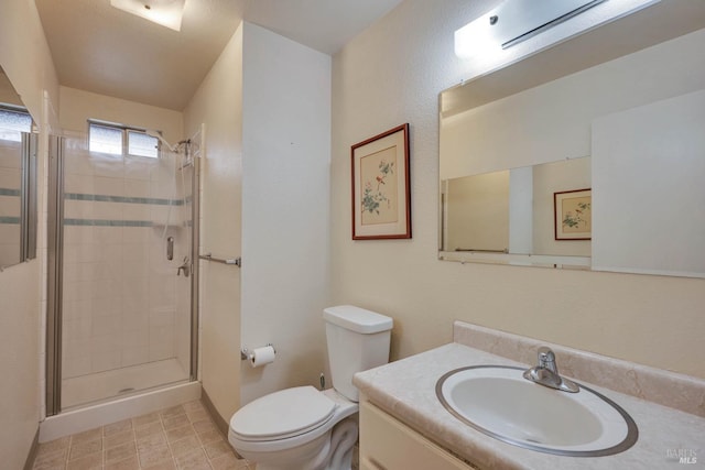 bathroom featuring an enclosed shower, vanity, and toilet