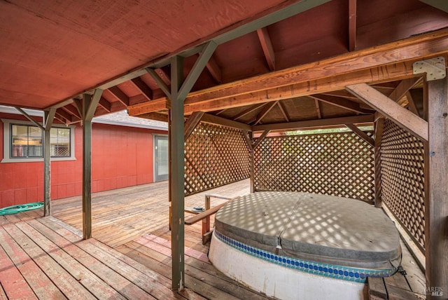 wooden terrace featuring a covered hot tub