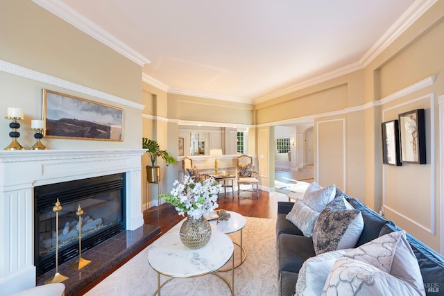 living room featuring crown molding, dark wood-type flooring, a fireplace, and baseboards