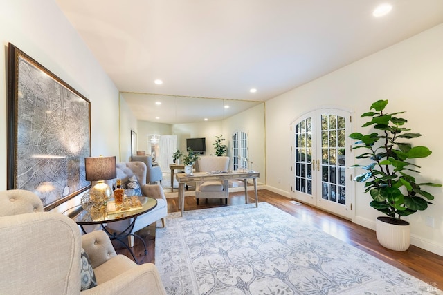 living room with recessed lighting, baseboards, wood finished floors, and french doors