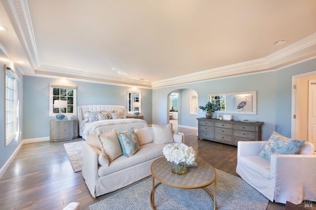 bedroom featuring ornamental molding, arched walkways, baseboards, and wood finished floors