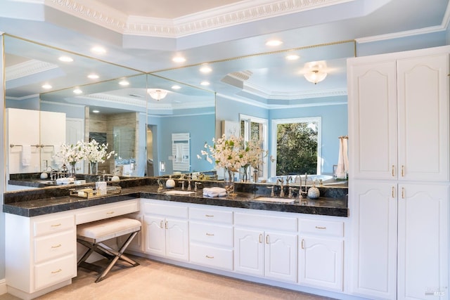 bathroom with ornamental molding, a stall shower, and a sink