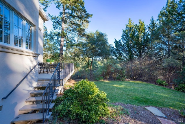 view of yard with stairway and outdoor dining area