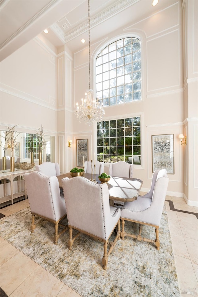 living area with a wealth of natural light, a high ceiling, and tile patterned floors