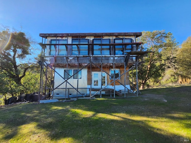 back of property featuring a yard