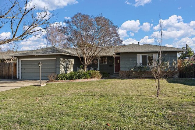 ranch-style home with a garage and a front yard