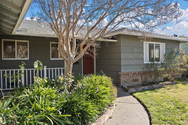 property entrance with a lawn